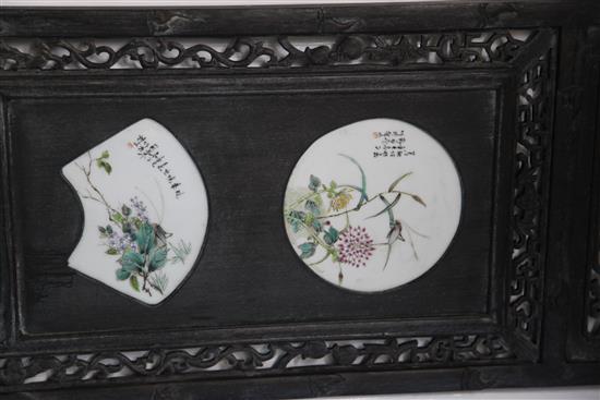 A pair of Chinese hardwood and porcelain mounted panels, 143.5 x 39.5cm.